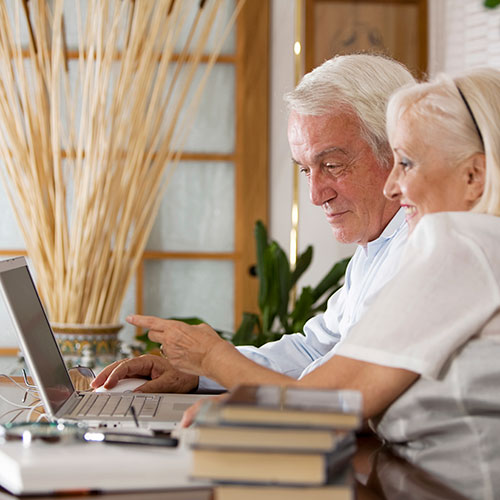 Elderly couple looking at computer.
