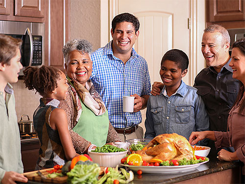 Photo: Family around a dinner table celebrating Thanksgiving.