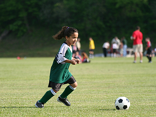 Photo: Girl playing soccer.