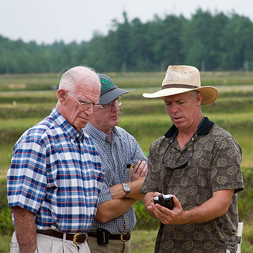 Three men participating in a precision ag demo.