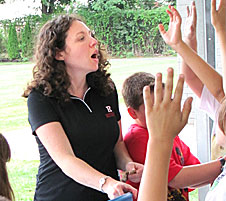 Photo: Teacher working with children.