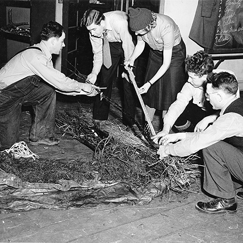 Photo: Students inspect a shipment of nursery stock during the Horticultural short course of the New Jersey College of Agriculture, Rutgers University. Pictured are, reading from left to right, Frank Johanson, assistant foreman in pomology; Warren Kline of Warrenville; Mrs. M. Hubert Hilder, Pattenburg; David Wishnefsky, Jersey Homestead and Instructor H. Malcolm Adams. January 1940.