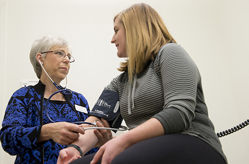 Photo: doctor taking blood pressure.