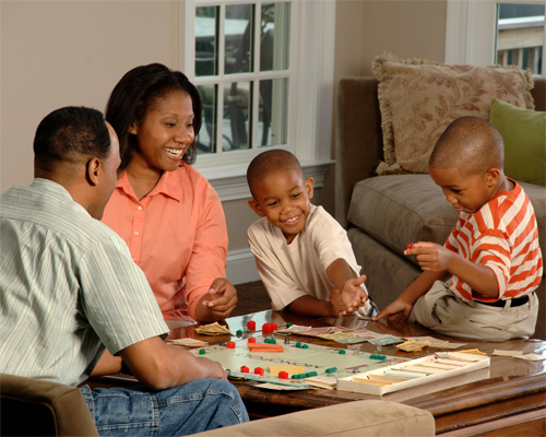 Photo: Family playing a board game.