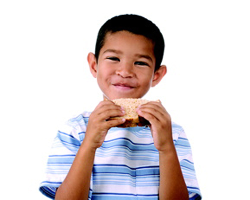 Photo: Boy eating a healthy snack.