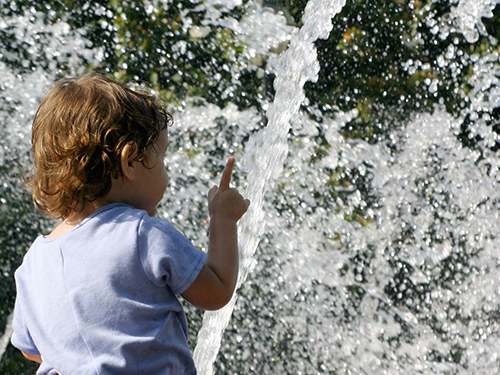Photo: Baby pointing at a water fountain.
