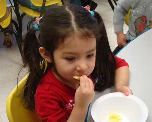 Photo: Girl eating a snack.