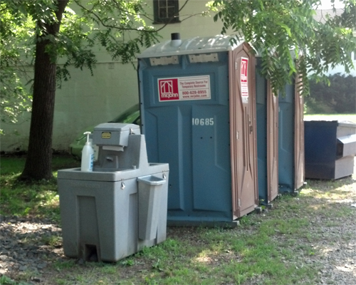 Photo: Portable restroom and hand washing station.