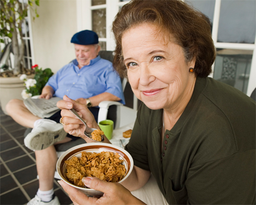 Photo:  Senior couple breakfasting on porch.