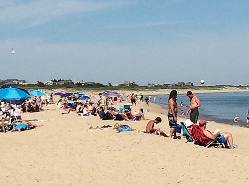 Beachgoers enjoy the sun, sand, and surf in Massachusetts.