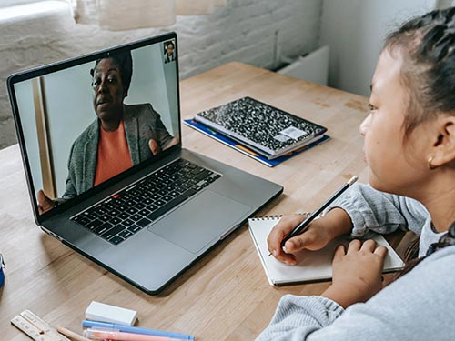 Female child watching a laptop computer.