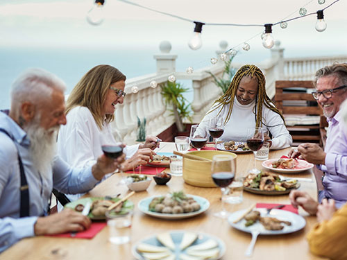 Older adults having tea or coffee together.