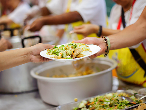 Photo: A plate of warm food handed out by charity workers.