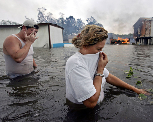 Photo: Man and woman walking to flooded area.