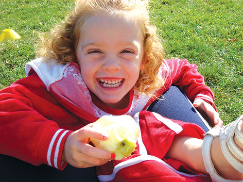 Photo: Child eating an apple.