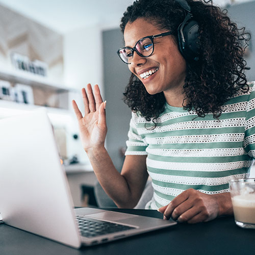 Woman greeting video conference call.