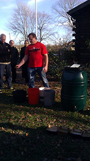 Photo: organic gardening, man standing in front of buckets.