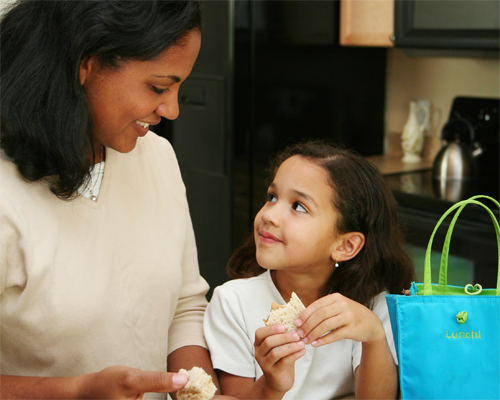 Photo: Mother and daughter holding snacks.