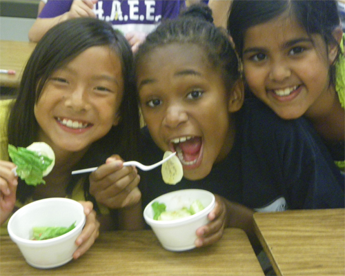 Photo: Group of children eating healthy snacks.