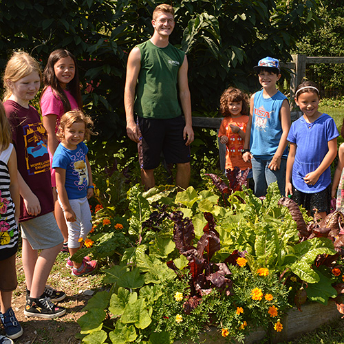 Rutgers Gardens volunteer with children.